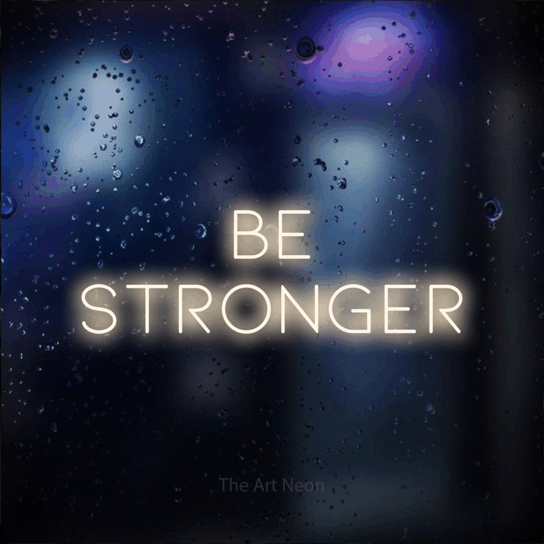 Warm white LED neon sign reading "Be Stronger" against a dark blue bokeh background for gym décor