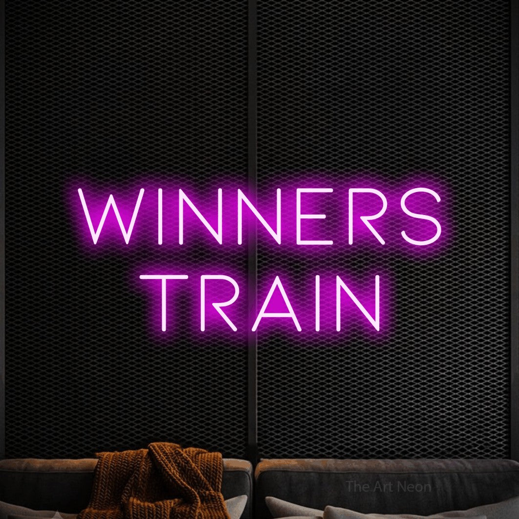 Pink LED neon sign reading "Winners Train" against a black textured wall for gym décor