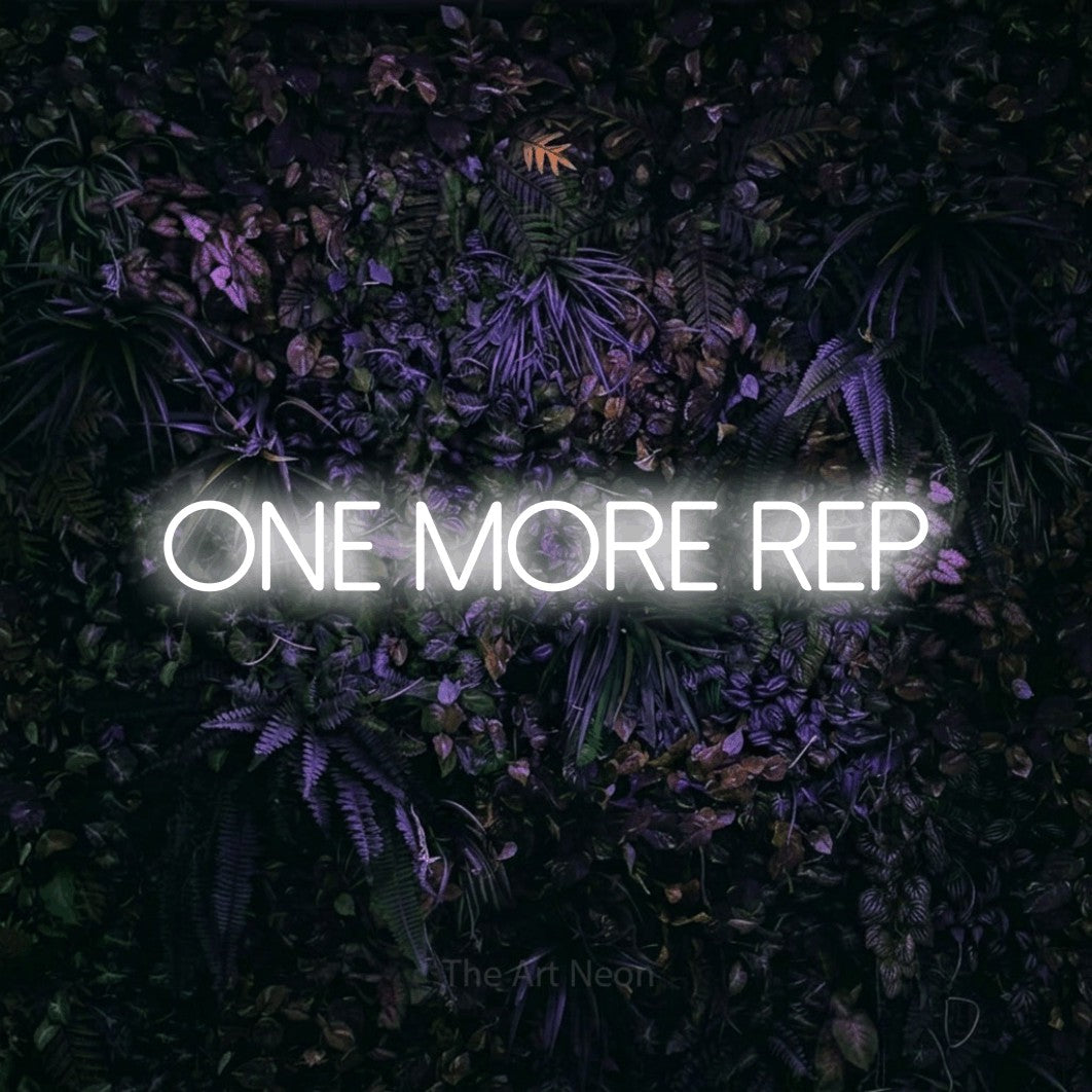 Cool white LED neon sign reading "One More Rep" against a purple floral wall for gym décor