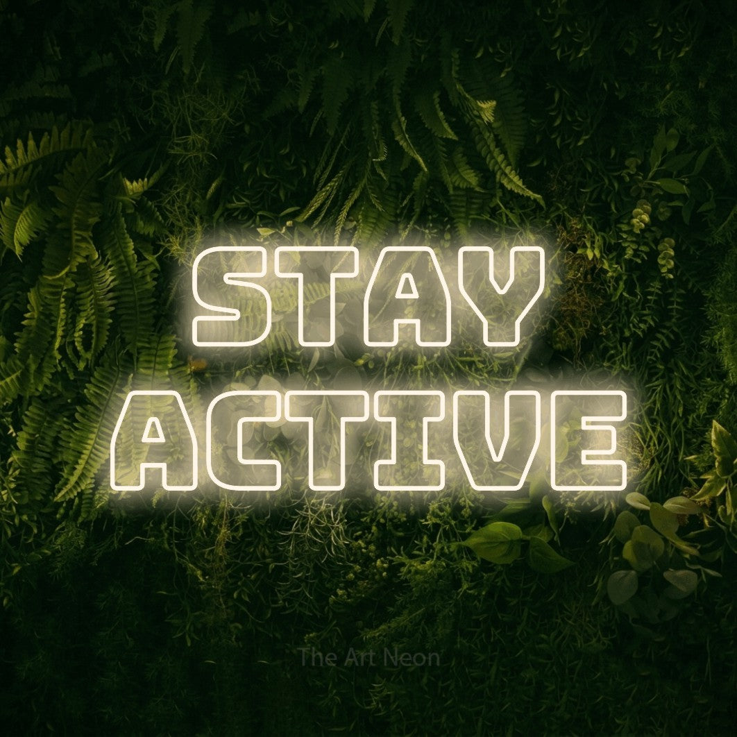 Warm white outline-style LED neon sign reading "Stay Active" against a moss-covered green wall for gym décor