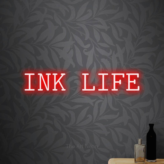 Red LED neon sign reading "Ink Life" against light grey floral wallpaper for tattoo studio décor