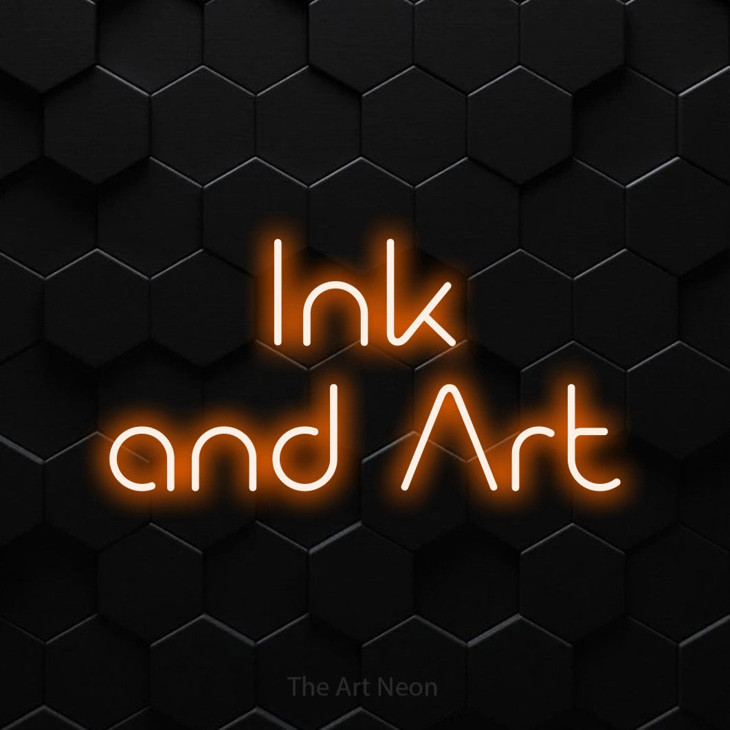 Orange LED neon sign reading "Ink and Art" against a black hexagonal wall for tattoo studio décor