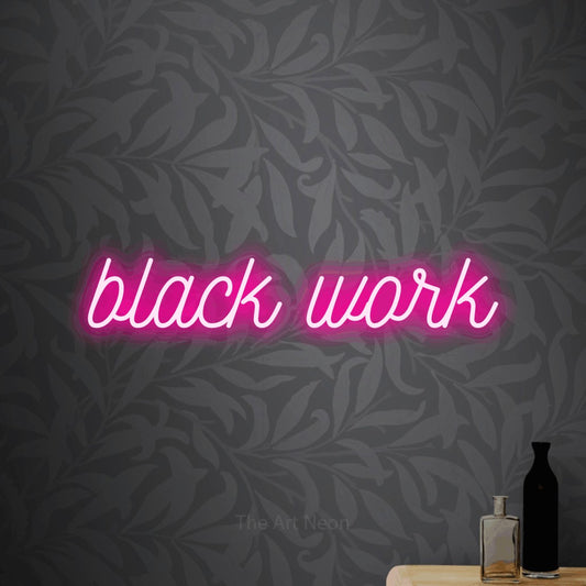 Hot pink script-style LED neon sign reading "Black Work" against light grey floral wallpaper for tattoo studio décor