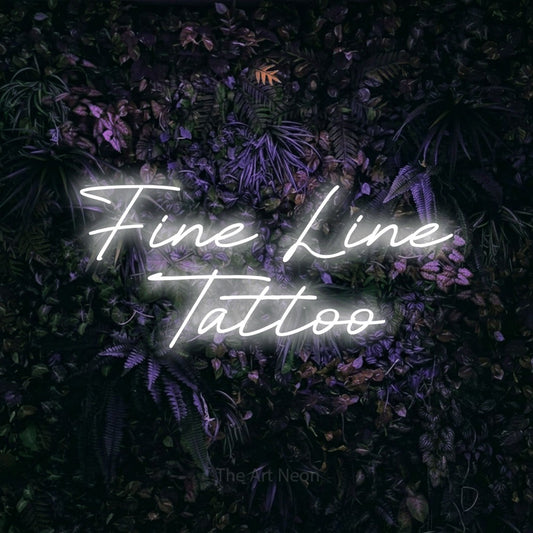 Cool white LED neon sign reading "Fine Line Tattoo" against a purple floral wall for tattoo studio décor