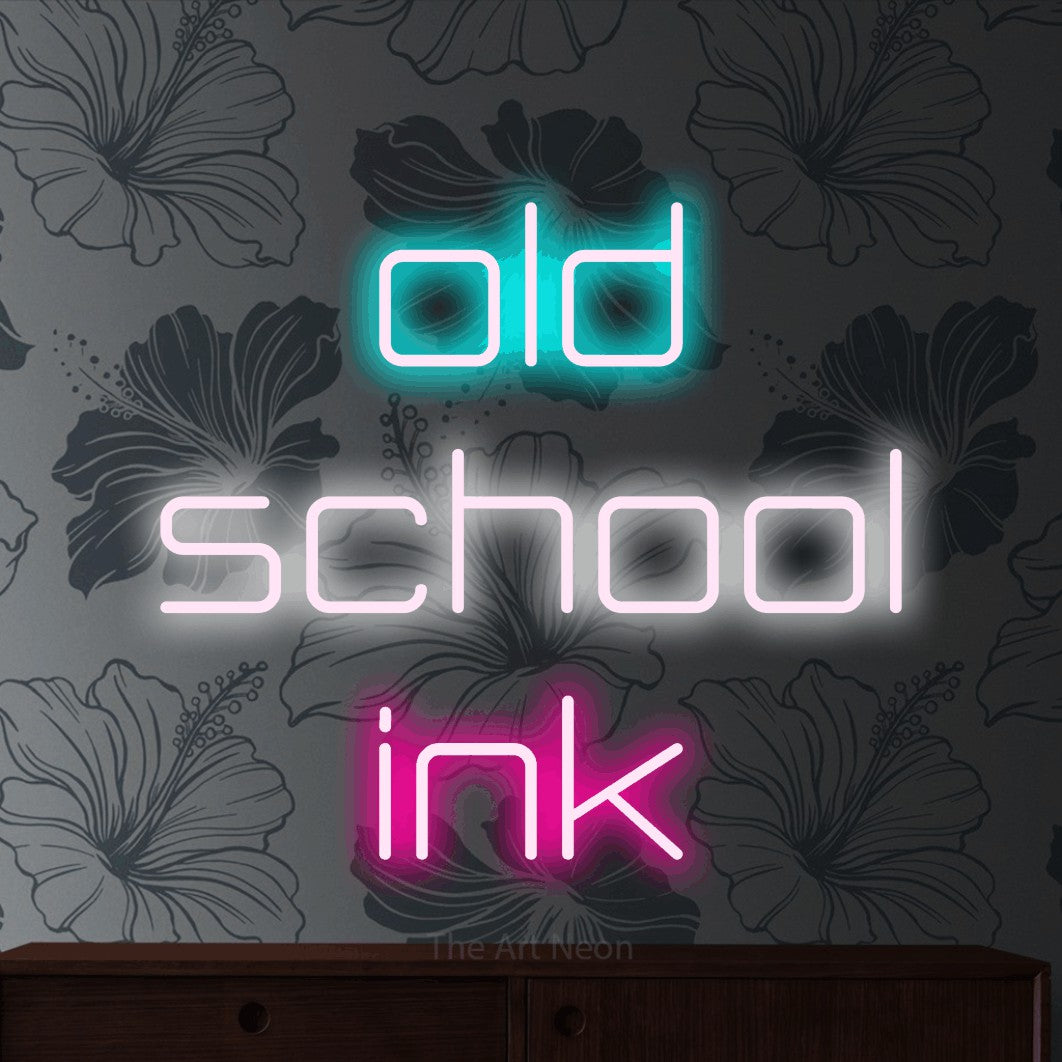 Multicolour LED neon sign reading "Old School Ink" against grey floral wallpaper for tattoo studio décor