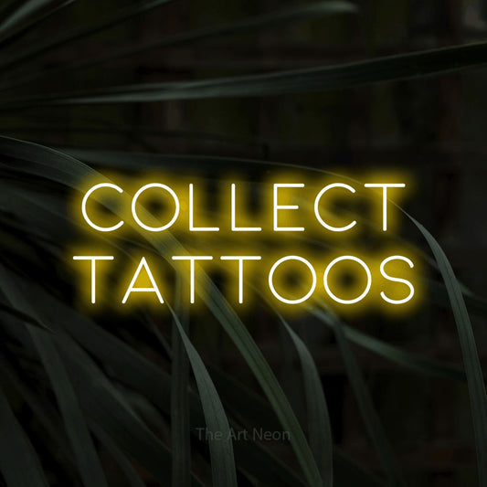 Yellow LED neon sign reading "Collect Tattoos" against dark tropical leaves for tattoo studio décor