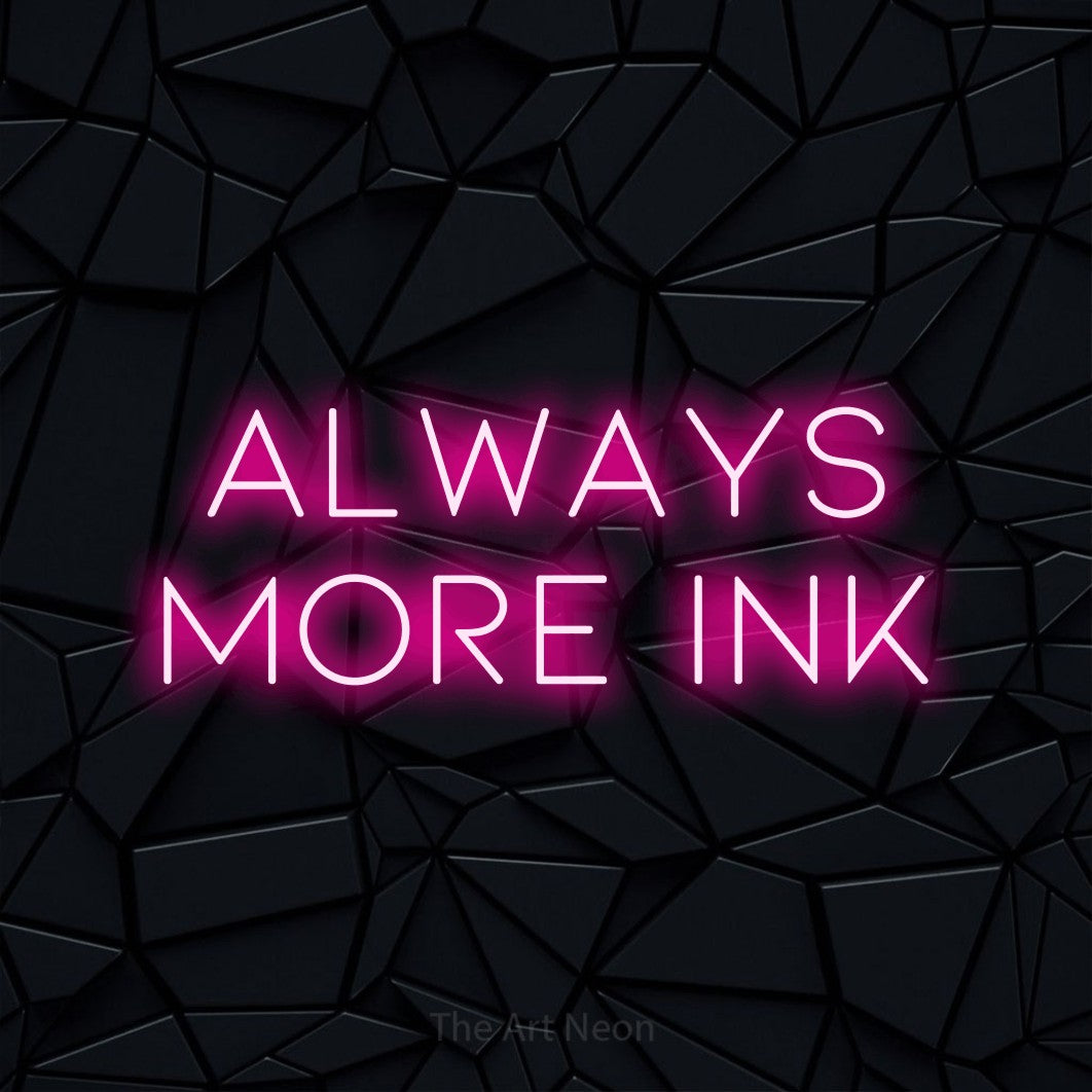 Hot pink LED neon sign reading "Always More Ink" against a black faceted wall for tattoo studio décor