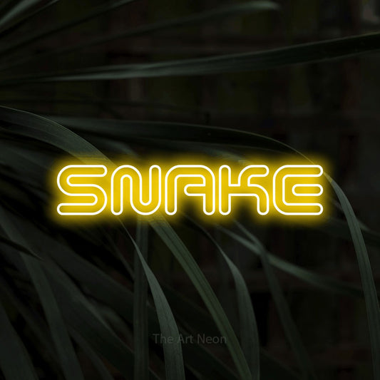 Yellow outline-style LED neon sign reading "Snake" against dark tropical leaves for tattoo studio décor