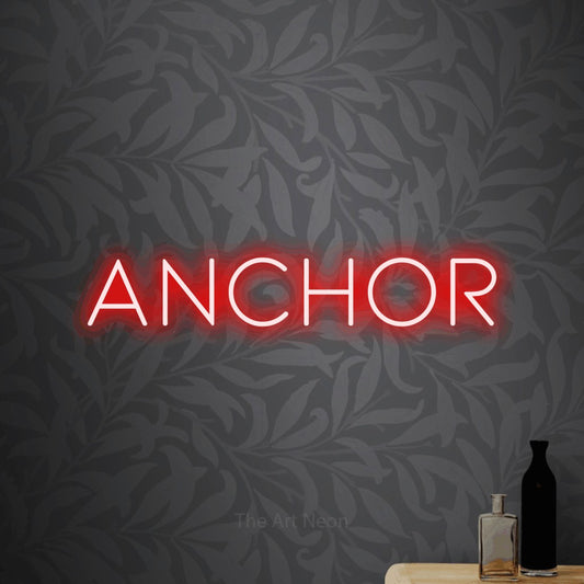 Red LED neon sign reading "Anchor" against light grey floral wallpaper for tattoo studio décor
