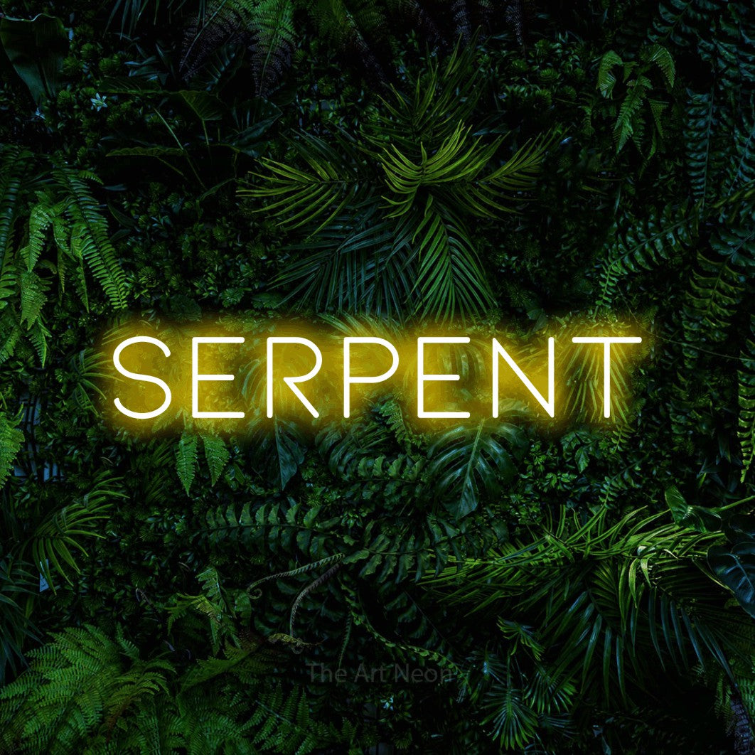 Yellow LED neon sign reading "Serpent" against a dense tropical foliage wall for tattoo studio décor