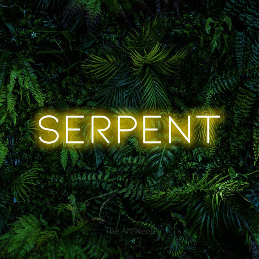 Yellow LED neon sign reading "Serpent" against a dense tropical foliage wall for tattoo studio décor