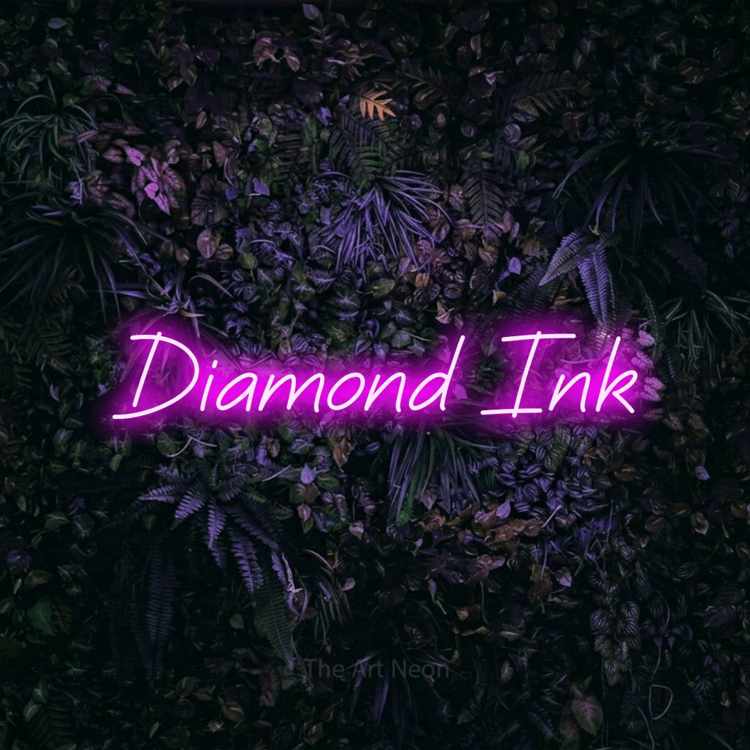 Pink LED neon sign reading "Diamond Ink" against a purple floral wall for tattoo studio décor