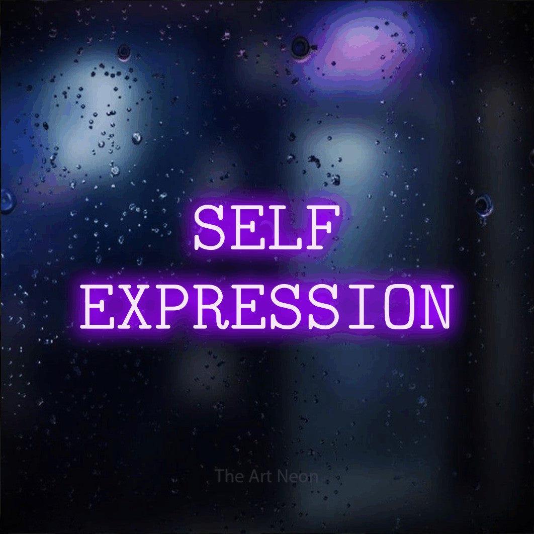 Purple LED neon sign reading "Self Expression" against a dark blue bokeh background for tattoo studio décor