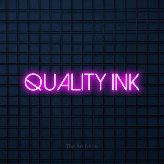 Pink LED neon sign reading "Quality Ink" against a dark blue tiled wall for tattoo studio décor