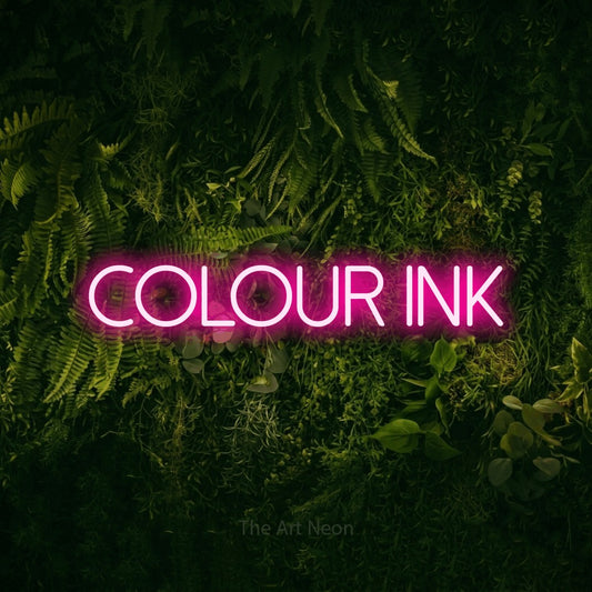 Hot pink LED neon sign reading "Colour Ink" against a moss-covered green wall for tattoo studio décor