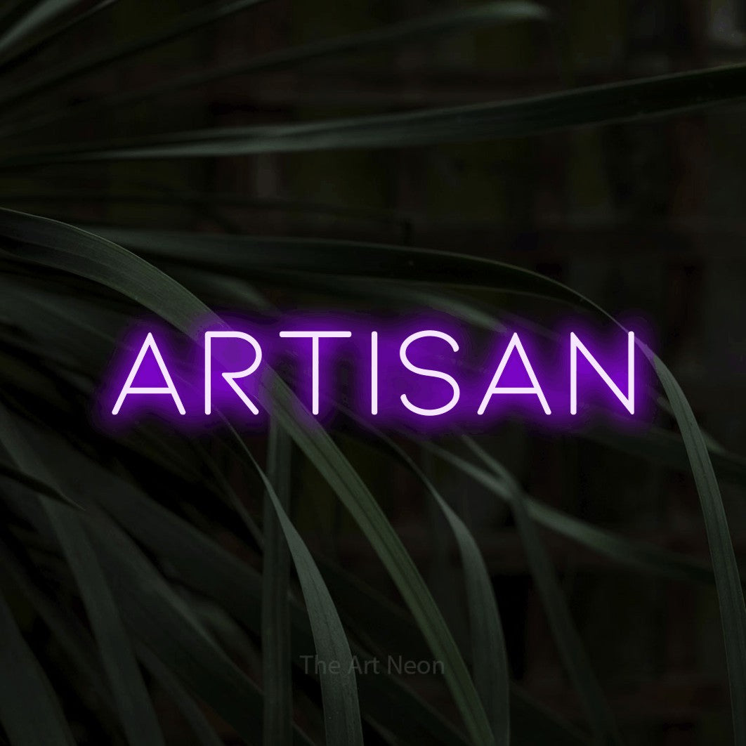 Purple LED neon sign reading "Artisan" against dark tropical leaves