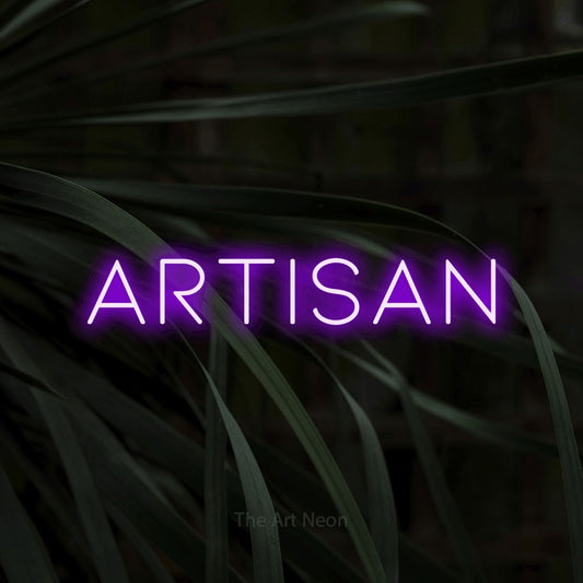 Purple LED neon sign reading "Artisan" against dark tropical leaves