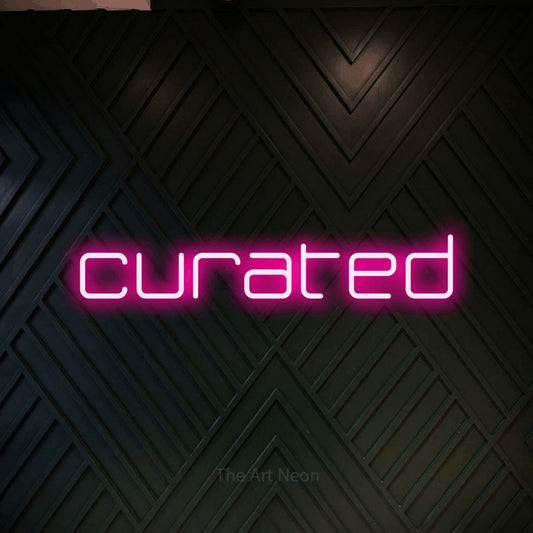 Hot pink LED neon sign reading "Curated" against a dark geometric wood wall