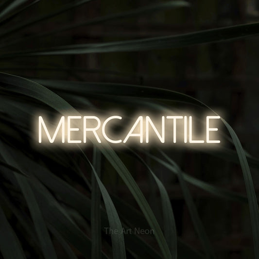Warm white LED neon sign reading "Mercantile" against dark tropical leaves