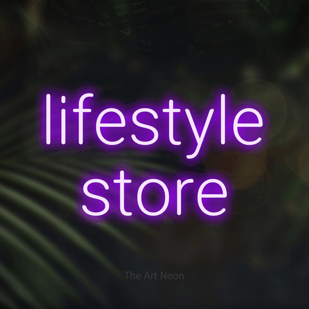 Purple LED neon sign reading "Lifestyle Store" against dark blurred palm leaves