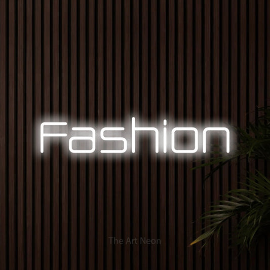 Cool white outline-style LED neon sign reading "Fashion" against dark wooden slats