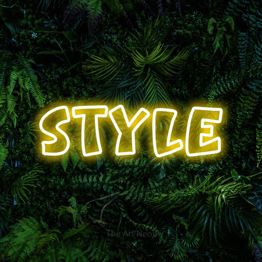Yellow outline-style LED neon sign reading "Style" against a dense tropical foliage wall