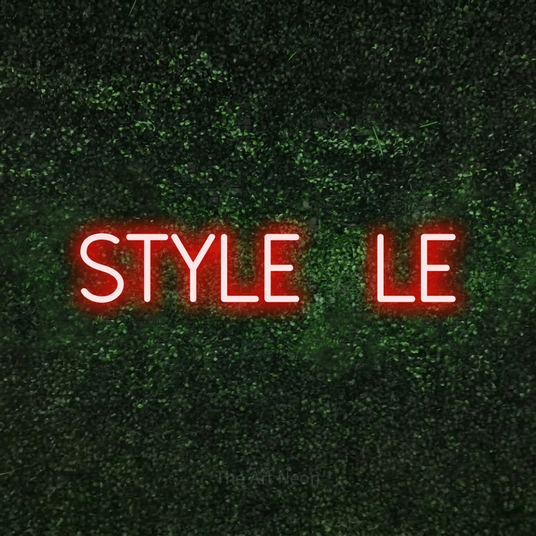 Red LED neon sign reading "Style File" against a textured green moss wall