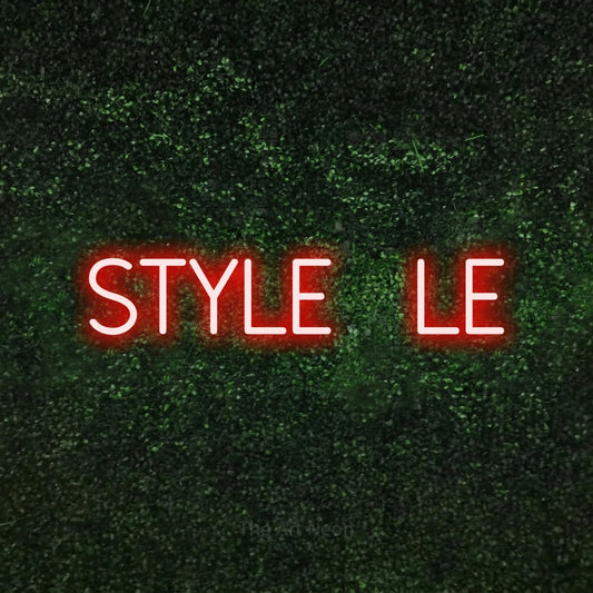 Red LED neon sign reading "Style File" against a textured green moss wall
