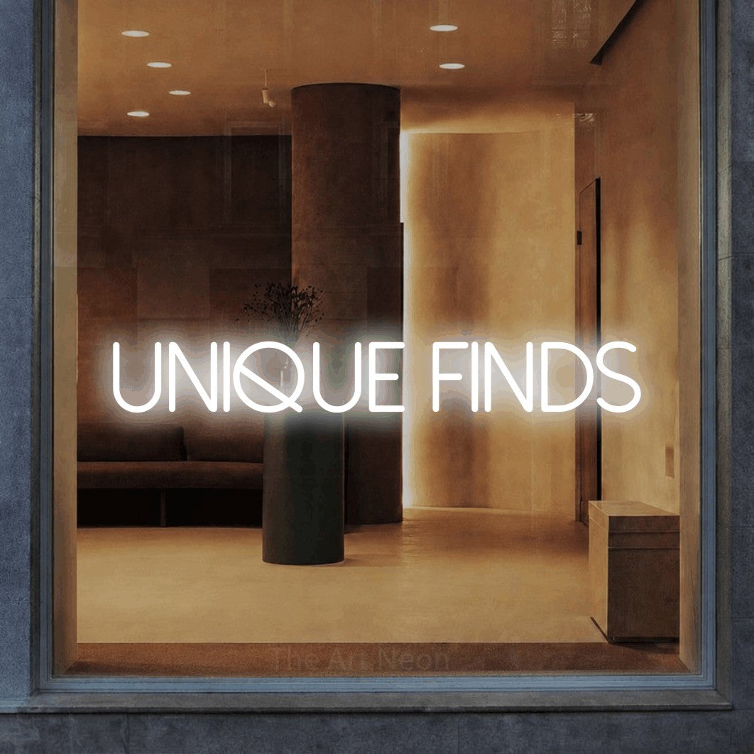 Cool white LED neon sign reading "Unique Finds" in a warm modern interior