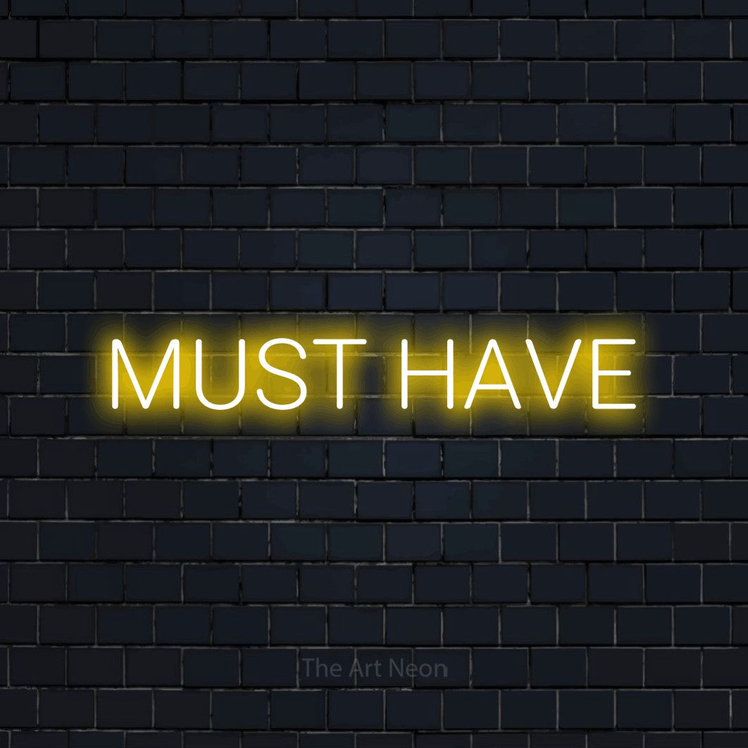 Yellow LED neon sign reading "Must Have" against a dark navy brick wall