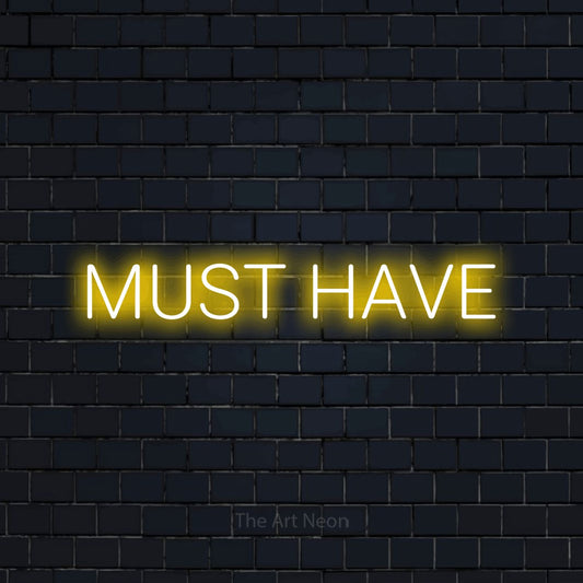 Yellow LED neon sign reading "Must Have" against a dark navy brick wall