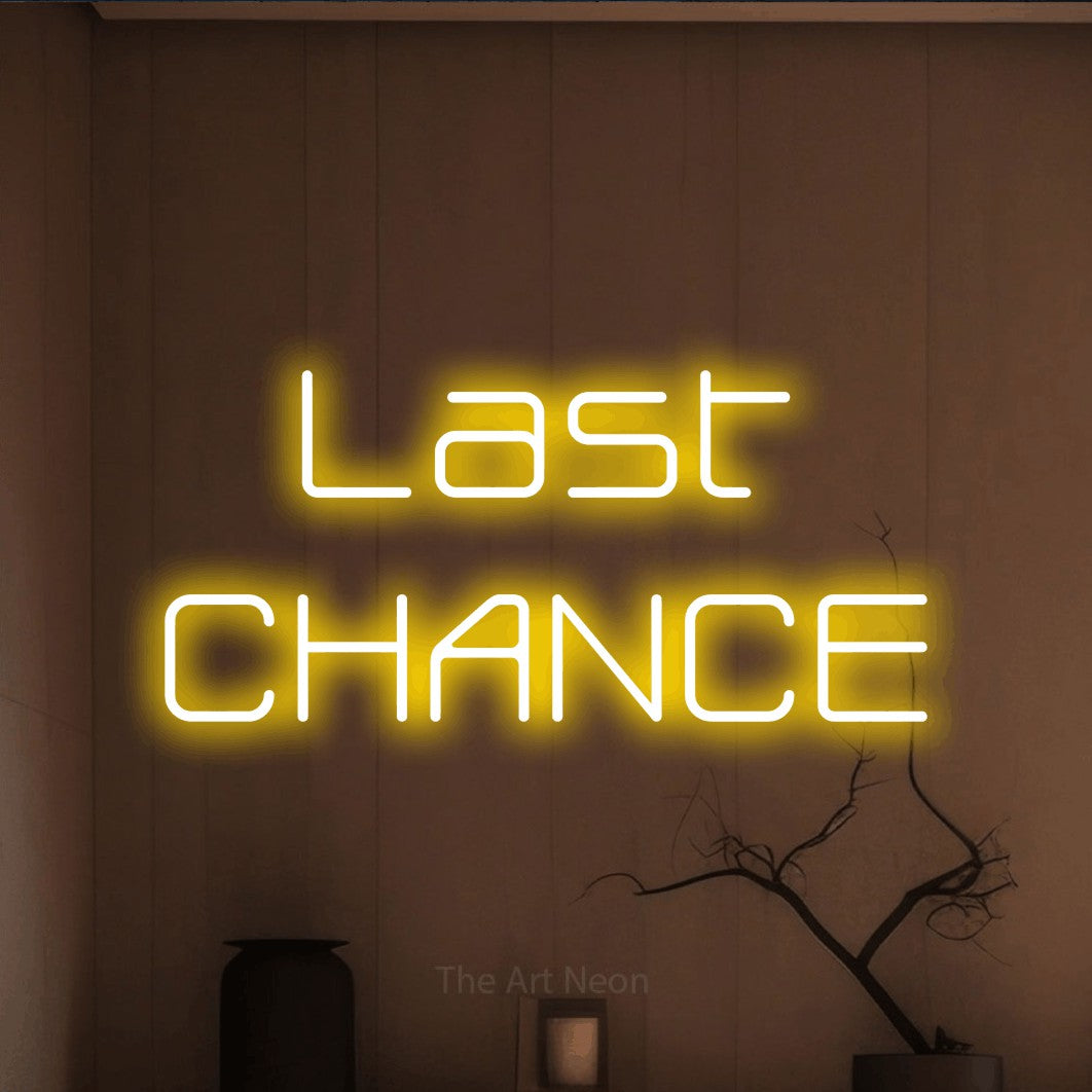Yellow LED neon sign reading "Last Chance" against a warm brown wall