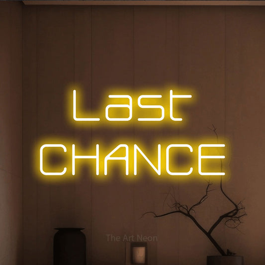 Yellow LED neon sign reading "Last Chance" against a warm brown wall
