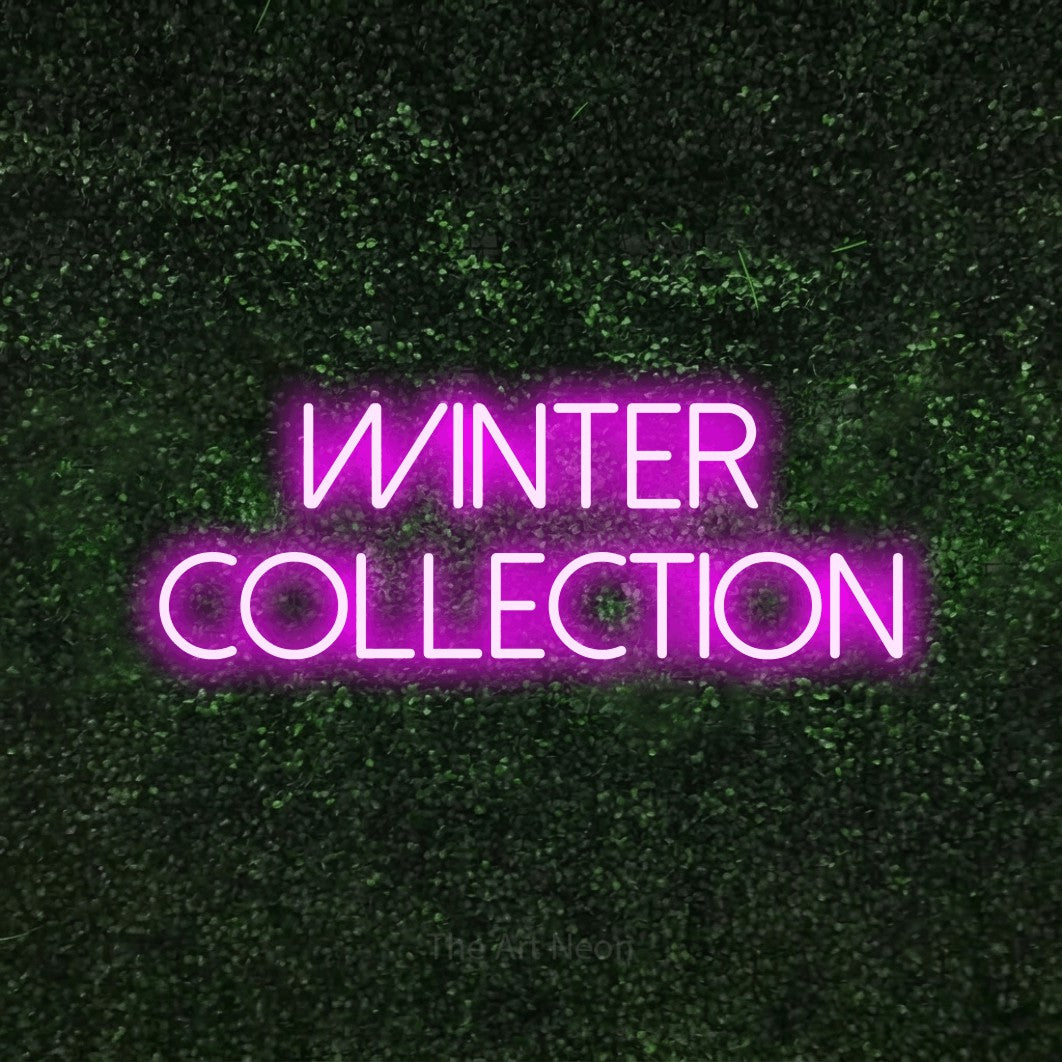Pink LED neon sign reading "Winter Collection" against a textured green moss wall