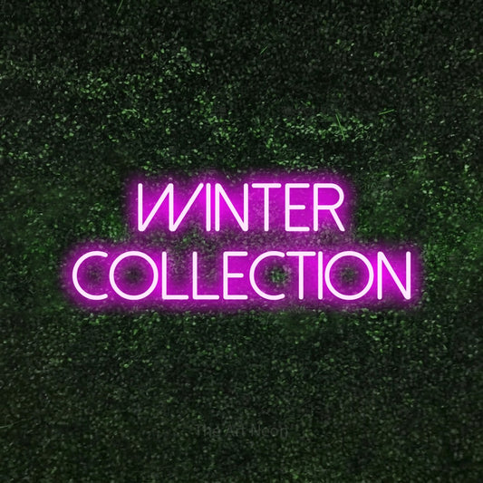 Pink LED neon sign reading "Winter Collection" against a textured green moss wall