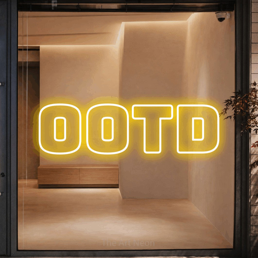 Yellow outline-style LED neon sign reading "OOTD" against a warm beige alcove wall