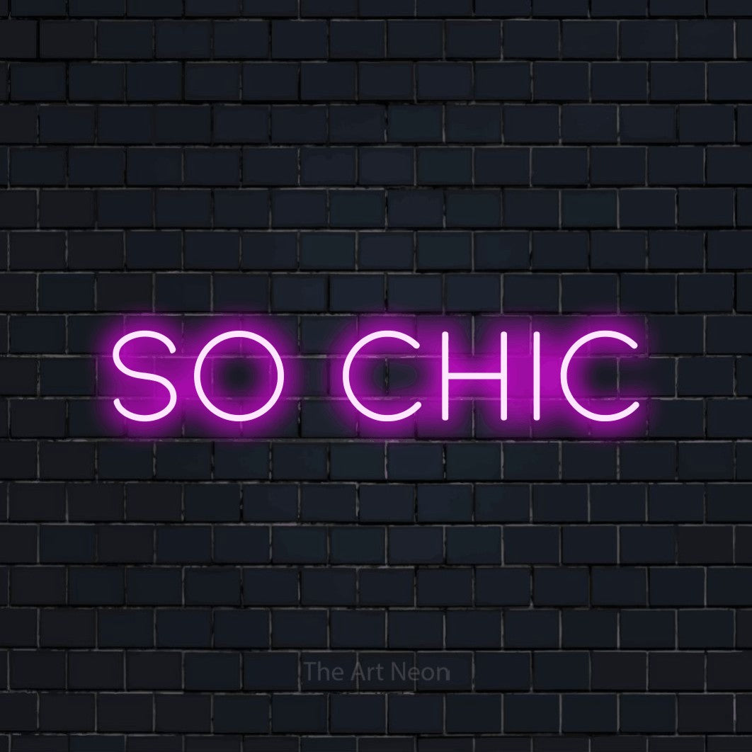 Pink LED neon sign reading "So Chic" against a dark navy brick wall