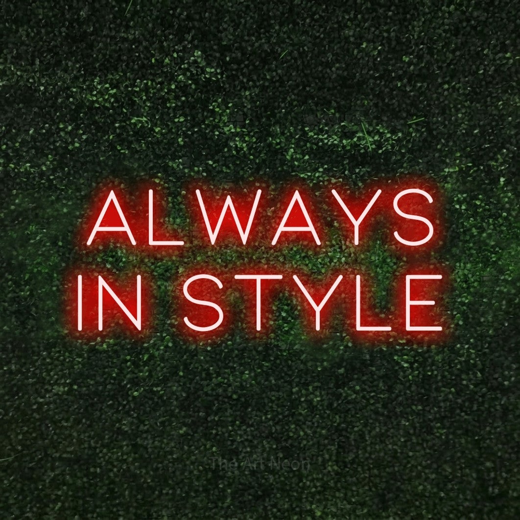 Red LED neon sign reading "Always in Style" against a textured green moss wall