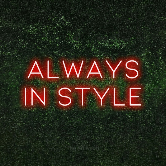 Red LED neon sign reading "Always in Style" against a textured green moss wall