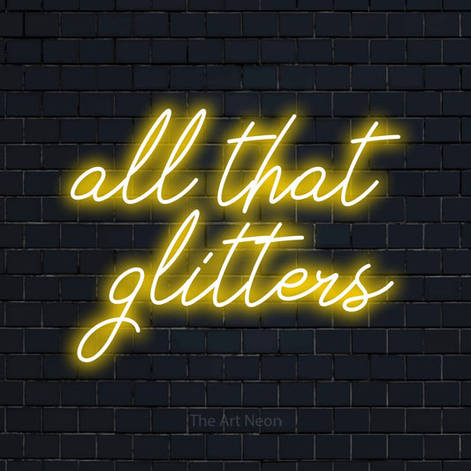Yellow script-style LED neon sign reading "All That Glitters" against a dark navy brick wall