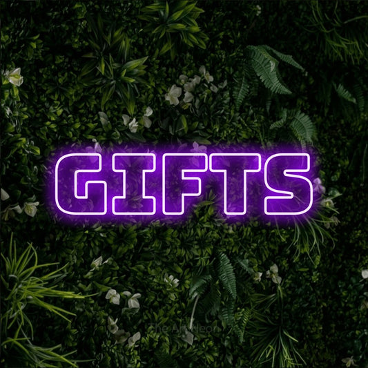 Purple outline-style LED neon sign reading "Gifts" against a leafy green wall