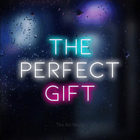 Multicolour LED neon sign reading "The Perfect Gift" against a dark blue bokeh background