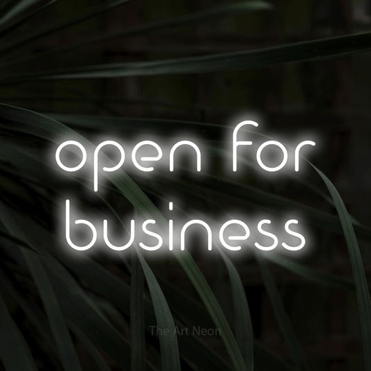 Cool white LED neon sign reading "Open for Business" against dark tropical leaves