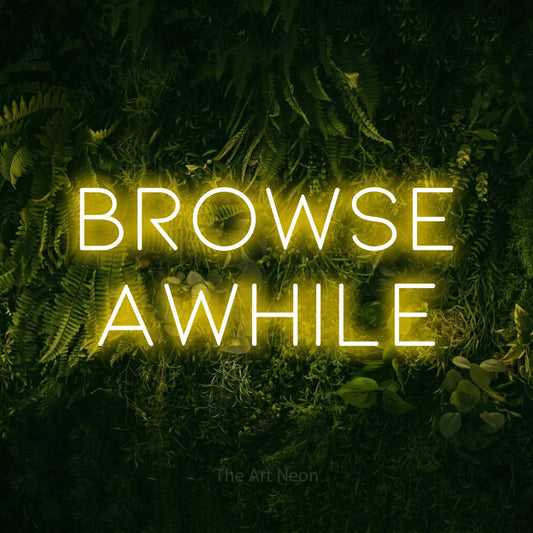 Yellow LED neon sign reading "Browse Awhile" against a moss-covered green wall