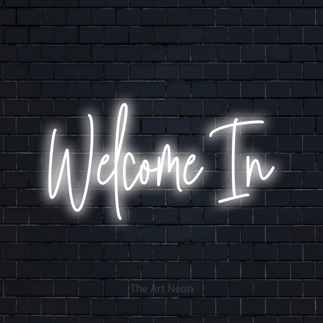 Cool white script-style LED neon sign reading "Welcome In" against a dark navy brick wall