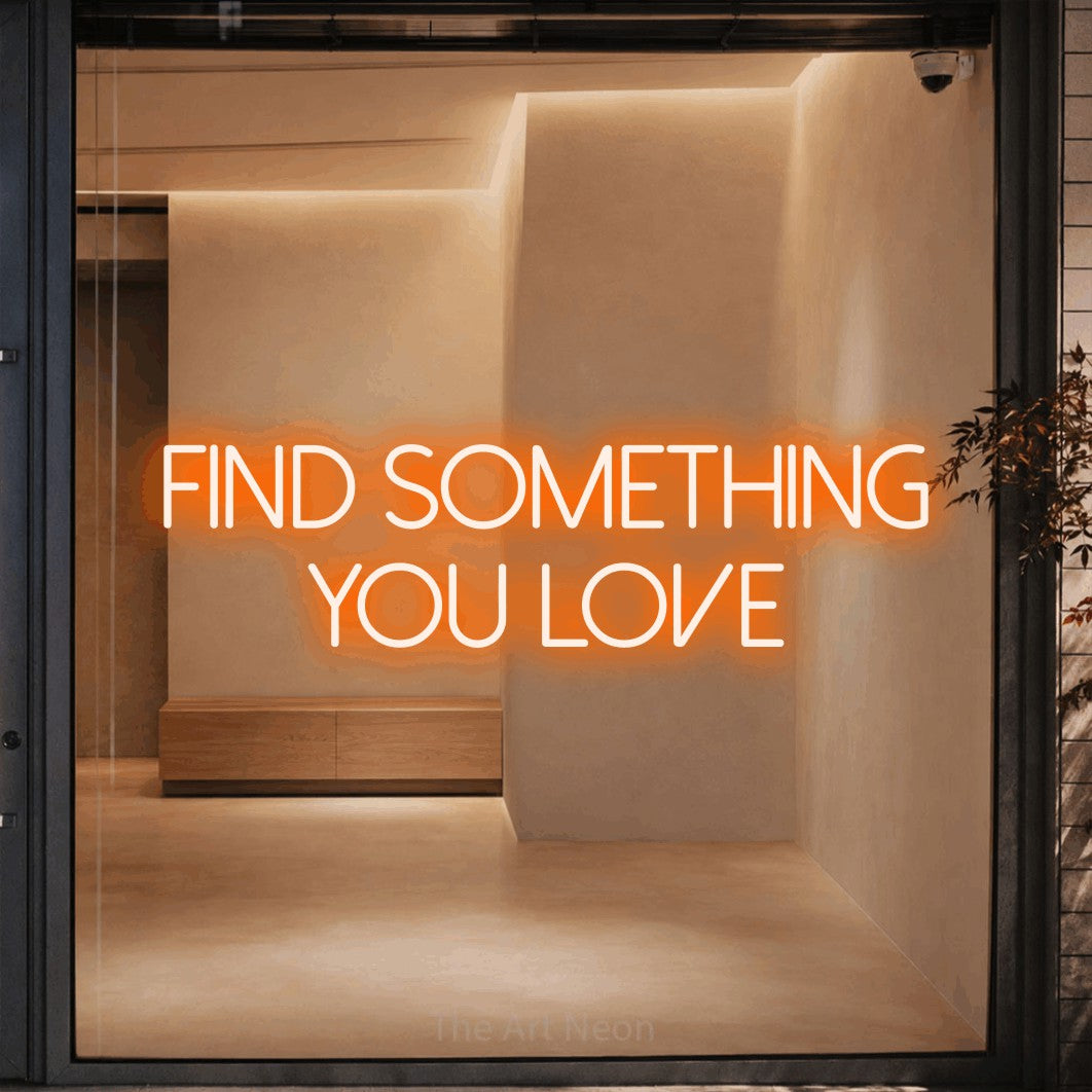 Orange LED neon sign reading "Find Something You Love" against a warm beige alcove wall
