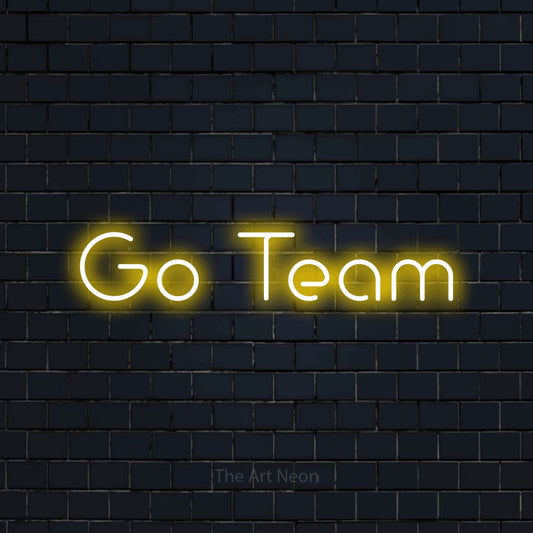 Yellow LED neon sign reading "Go Team" against a dark navy brick wall for office décor