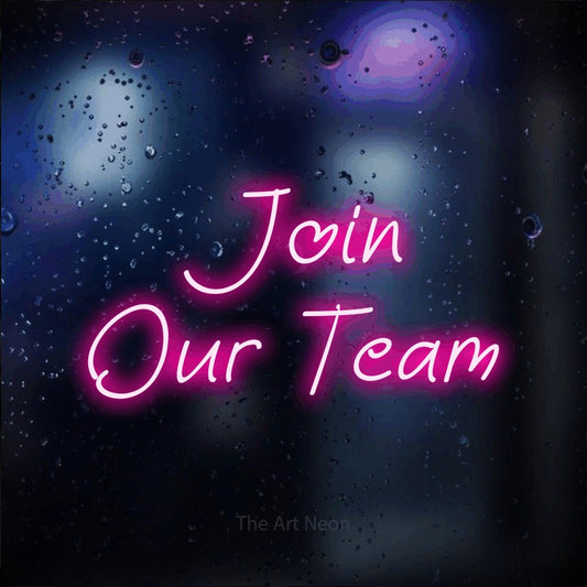 Hot pink LED neon sign reading "Join Our Team" against a dark blue bokeh background for office décor