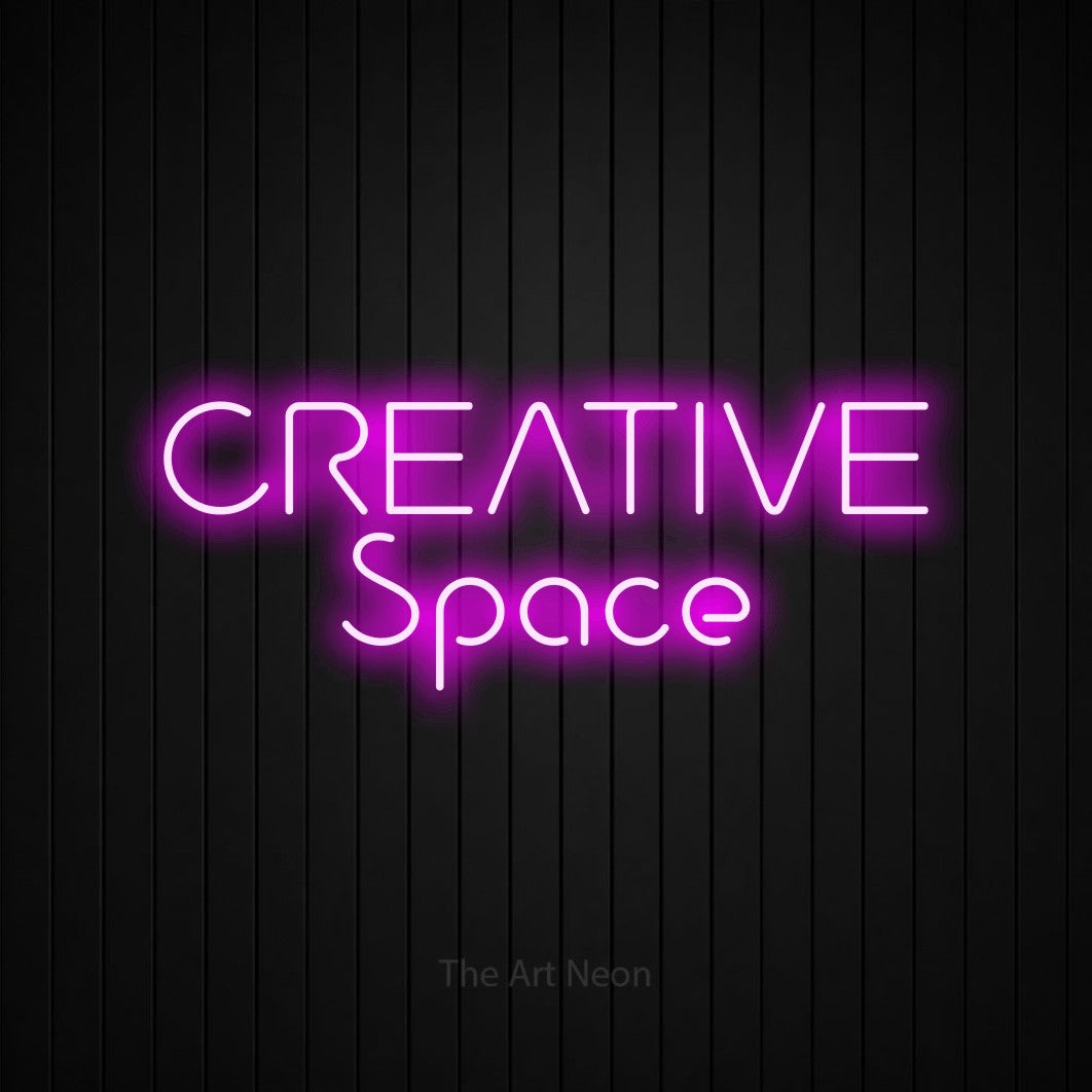 Pink LED neon sign reading "Creative Space" against a black vertical slat wall for office décor