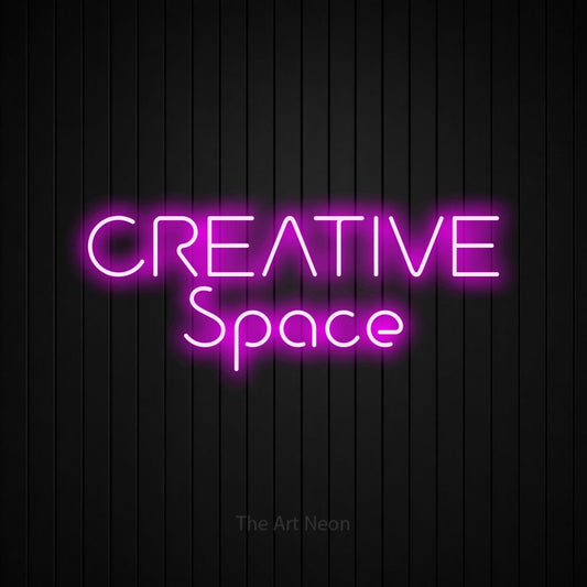 Pink LED neon sign reading "Creative Space" against a black vertical slat wall for office décor